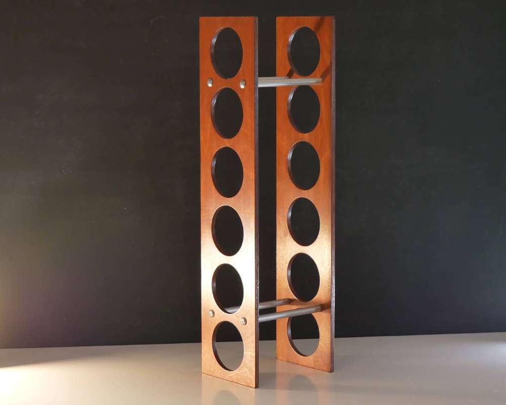 simple dark wood wine rack with six holes for storing wine bottles in horizontal position.