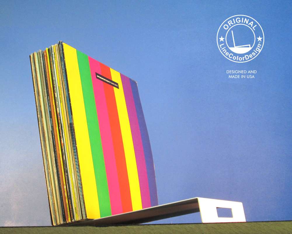 a modern metal stand holding colorful vinyl records